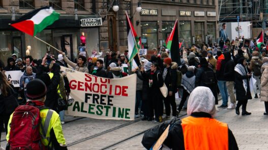 a group of people walking down a street holding flags