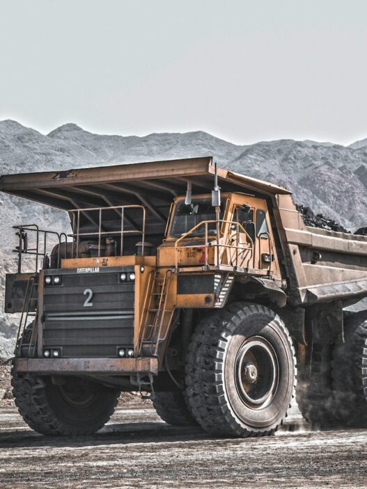 yellow and black heavy equipment on snow covered ground during daytime